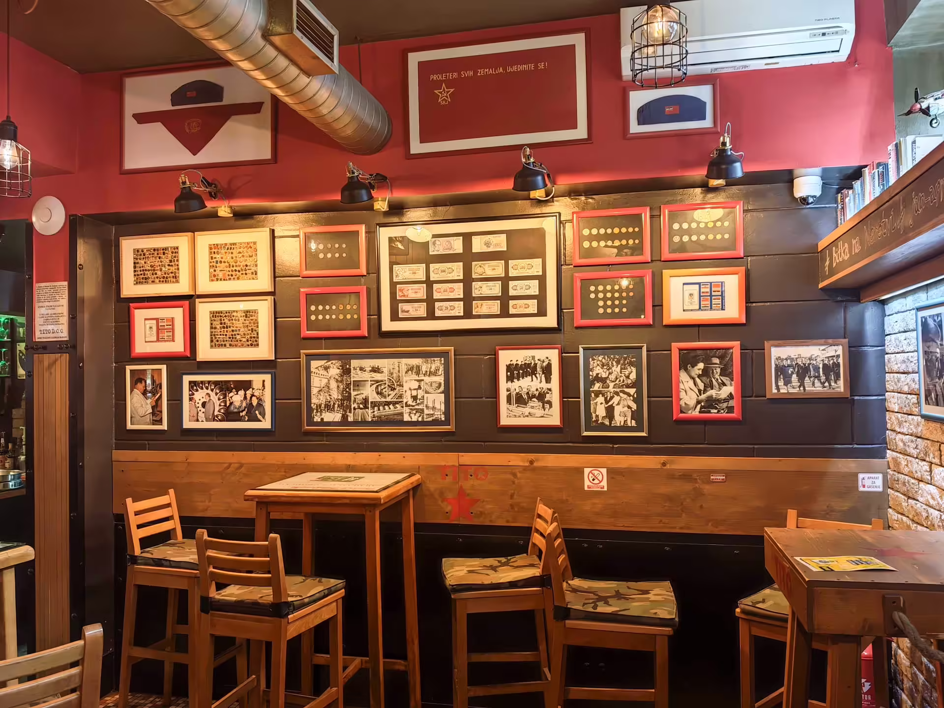 Stena Cafe Tito so zbierkami mincí, bankoviek, fotografií a dobovou výzdobou
