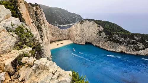 Pohľad z útesu na pláž Navagio na Zakynthose s vrakom lode Panagiotis, bielymi skalami a modrou zátokou